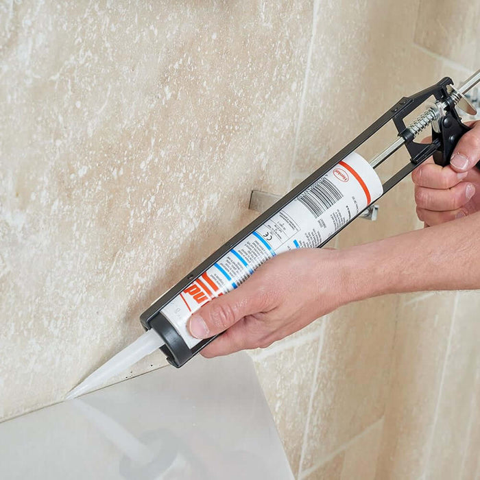 An image of an 11" Silicone Gun / Skeleton Gun with a tube of sealant being applied to tiles.