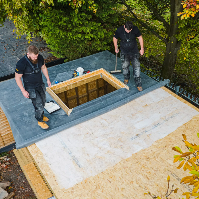 An image of some EPDM rubber roofing on a roof using FlexiProof WBA Roof Deck Adhesive to secure the rubber sheet to the roof.