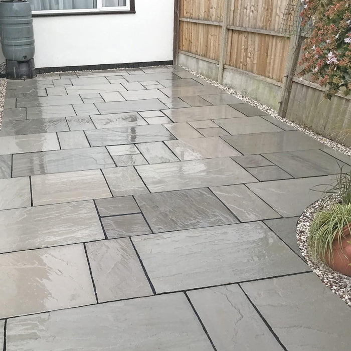 An image of Kandla Grey Indian Sandstone Paving laid out to show what it looks like when wet.