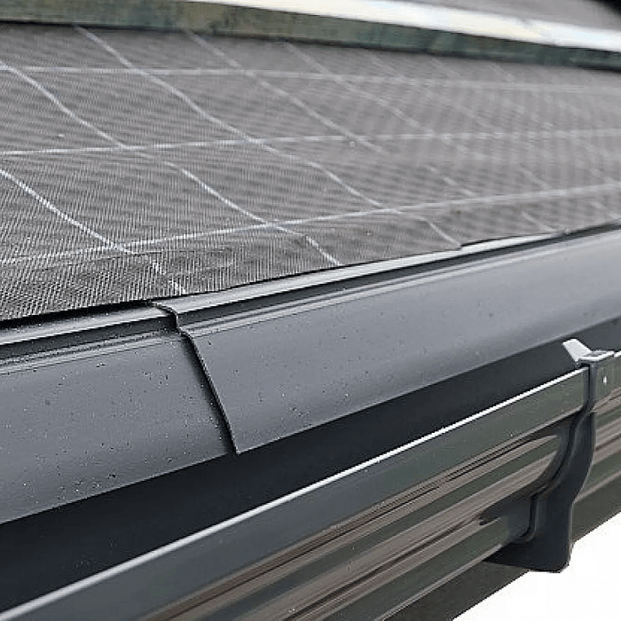 An image of Manthorpe Eaves Guard Felt Support Tray and how this looks when installed on the eaves of a roof above guttering.