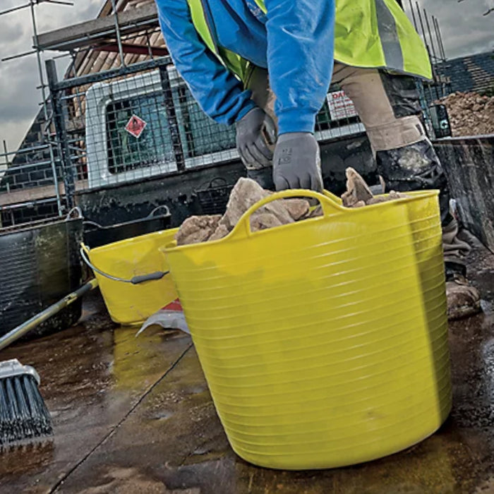 Image of a Red Gorilla Medium Tub in Yellow with a capacity of 26 litres being used to transport and move rubble / stones/ debris.