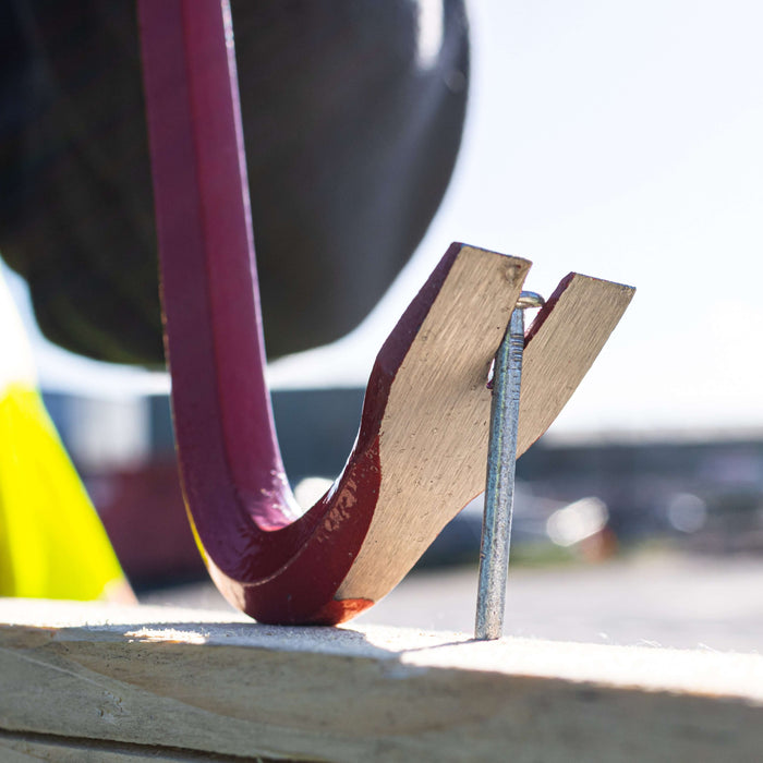 An image of a Timco Wrecking Bar / Crowbar being used to remove a nail from wood.