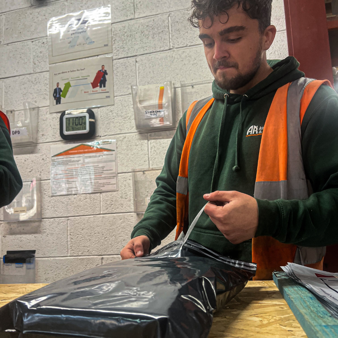 Ashbrook Roofing Supplies worker packing felt lap vents