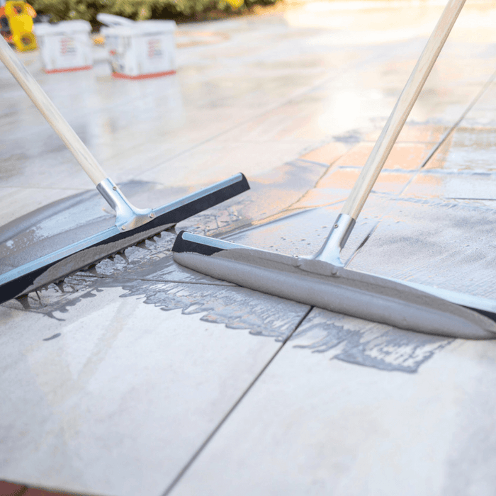 An image of Azpects Slurry Grout being pushed into gaps in paving as a jointing compound