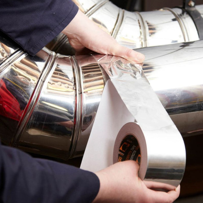 An image of a roll of Aluminium Foil Tape being applied to a metal pipe.