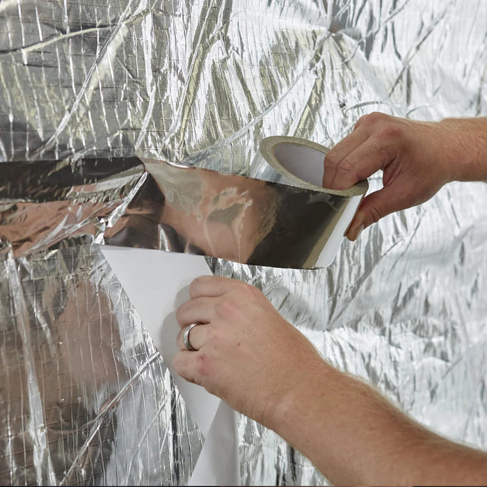 An image of a roll of Aluminium Foil Tape being applied to insulation.