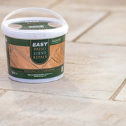 An image showing Azpects EASY Patio Joint Repair in the colour Grey Beige on some paving showing what it looks like when laid.