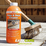 An image of Azpects EASYCare Patio & deck cleaner in a 1 litre bottle on a patio with a brush with the product on it.