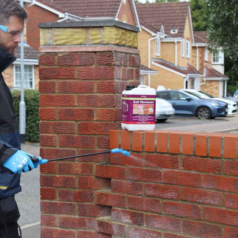An image of a wall being treated with Azpects EASYCare Salt Remover with the 3 litre bottle.