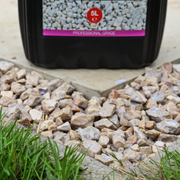 An image showing stones once Azpects EASYScape Gravel Hold has been poured onto chippings / gravel / aggregates but before it has dried and cured.