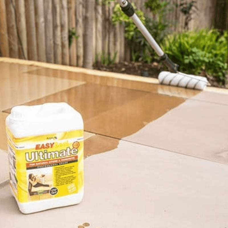 An image of Azpects EasySeal Ultimate being applied to paving with the tub in the foreground.