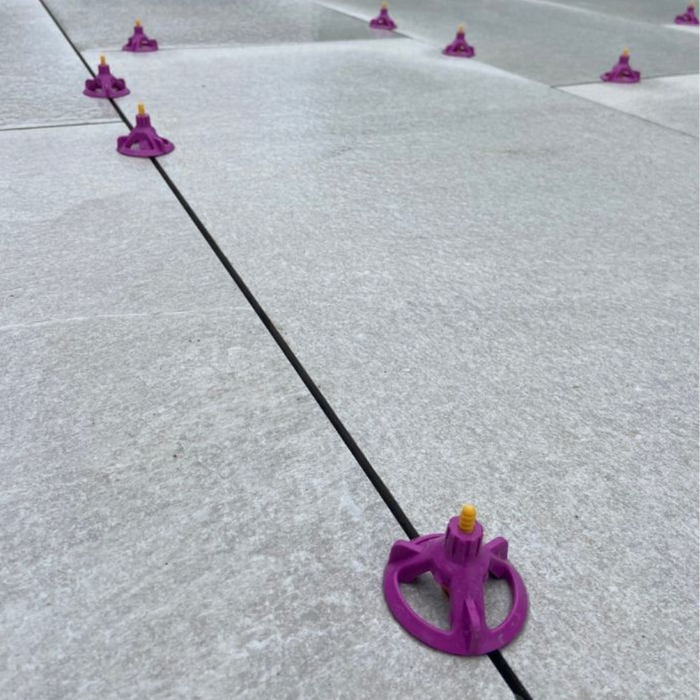 An image of Azpects EASY Tile Align Levelling Caps being fitted to line up paving.