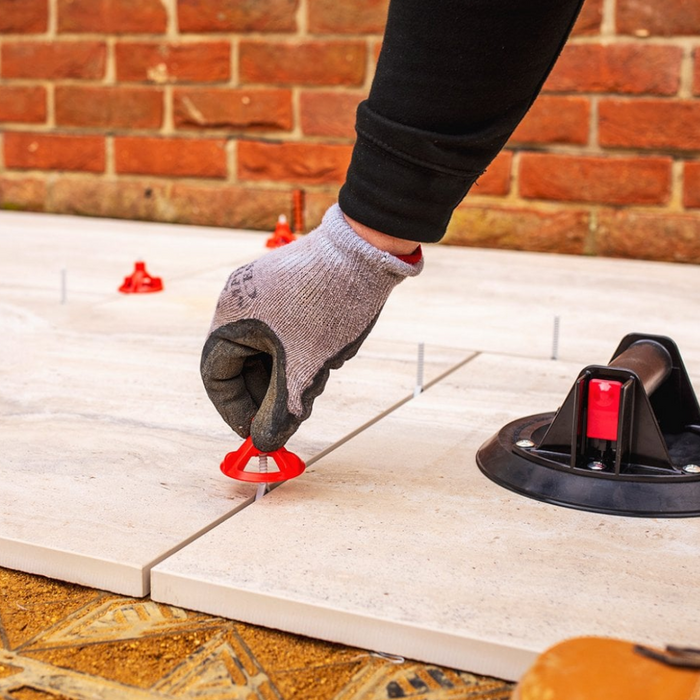 An image of Azpects EASY Tile Align Levelling Caps being fitted to line up paving.