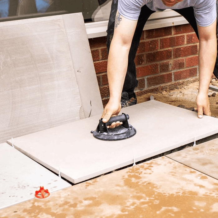 An image Azpects EASY Tile Align Spacer Posts being installed ready to level out and pay paving slabs