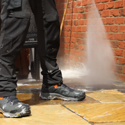 An image of a patio being rinsed off after being treated with Azpects Patio Snow Foam.