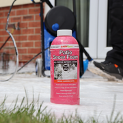 An image of Azpects Patio Snow Foam in a 1 Litres bottle sat on a patio covered with foam being cleaned.