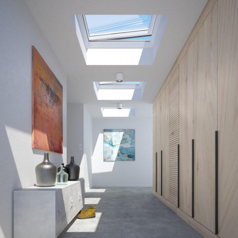 An image showing three Azure Vented flat roof windows FRE B600 and how they light up a hallway / corridor