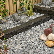 An image showing Artico White Marble Stone Aggregate Chippings when laid as part of a garden.