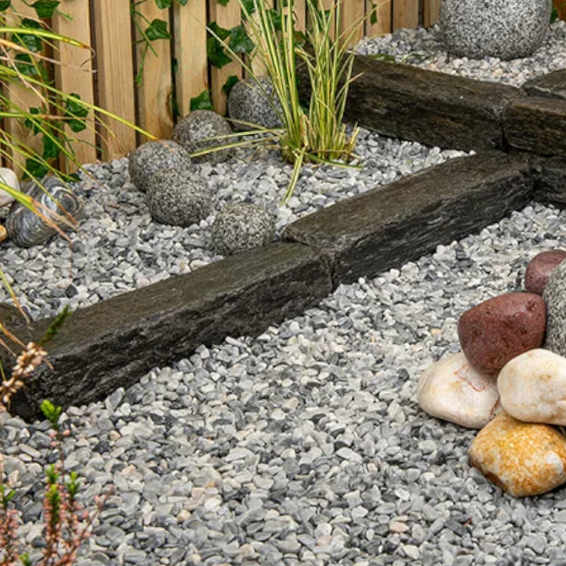 An image showing Artico White Marble Stone Aggregate Chippings when laid as part of a garden.