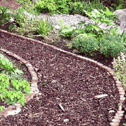 Image of landscaping bard wood mulch used on a path to show what it would look like. They are brown tones and are supplied in a bulk bag