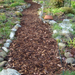 Image of landscaping bard wood mulch used on a path to show what it would look like. They are brown tones and are supplied in a bulk bag