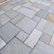 Image of Bond-it Indian Stone Sealer applied to grey Indian sandstone paving to show the effect.
