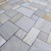 Image of Bond-it Indian Stone Sealer applied to grey Indian sandstone paving to show the effect.