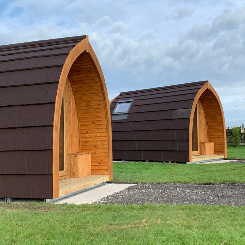 An image of wooden / Timber Camping Pods covered with Britmet Lightweight Metal Roof Tile Slate 2000