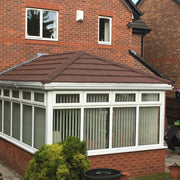 An image of a Conservatory covered with Britmet Lightweight Metal Roof Tile Slate 2000