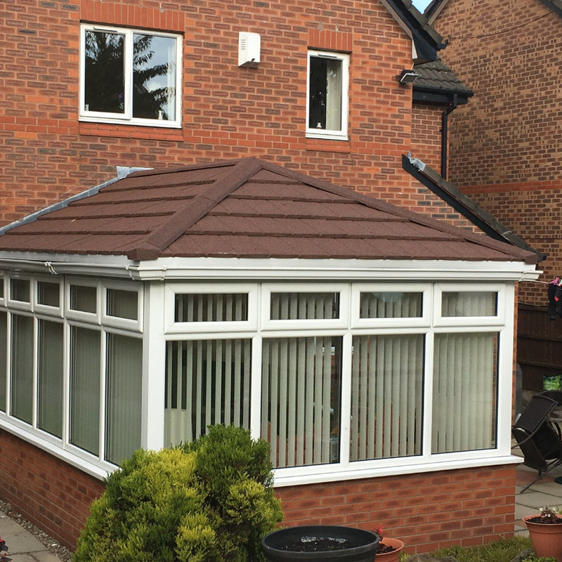 An image of a Conservatory covered with Britmet Lightweight Metal Roof Tile Slate 2000