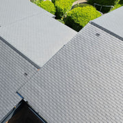 An image of a roof with Britmet LiteSlate Tiles and with a Vent build in.