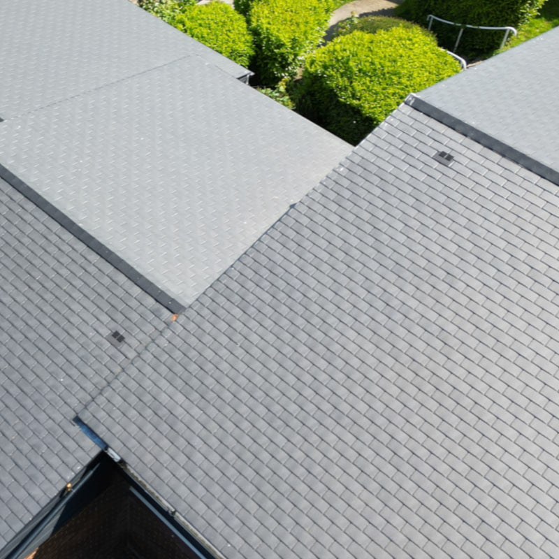 An image of a roof with Britmet LiteSlate Tiles and with a Vent build in.
