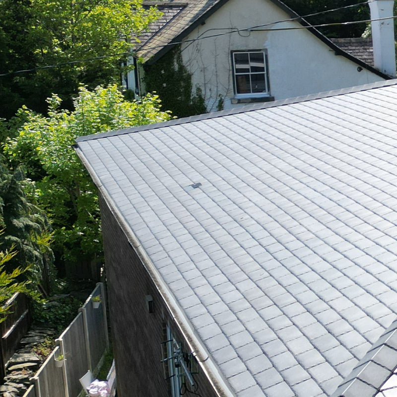 An image of a roof with Britmet LiteSlate Tiles and with a Vent build in.