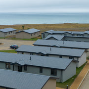 An image showing Britmet Liteslate lightweight roof tiles fitted to a number of buildings in a holiday park