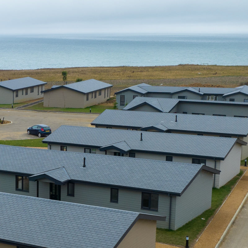 An image showing Britmet Liteslate lightweight roof tiles fitted to a number of buildings in a holiday park