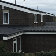 An image of a roof with Britmet Pantile 2000 Low Pitched shingles and with Apron Flashing abutments 