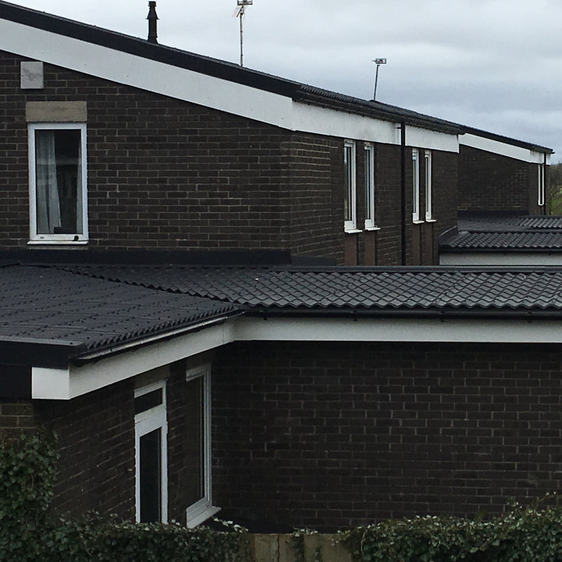 An image of a roof with Britmet Pantile 2000 Low Pitched shingles and with Apron Flashing abutments 