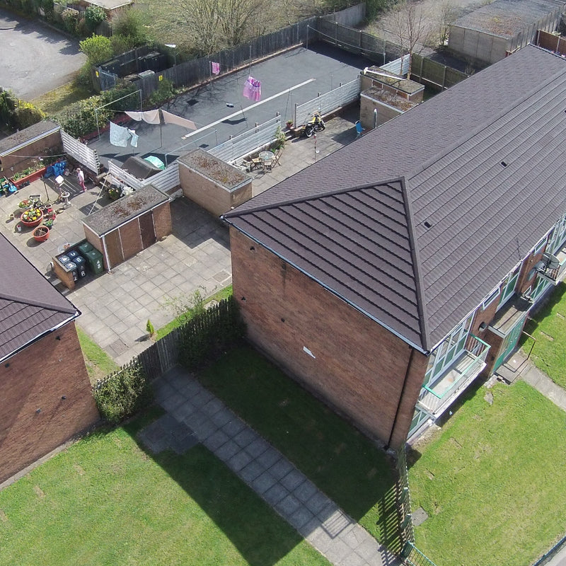 An image of a house with Britmet Pantile 2000 Roof tiles and Hip End Caps in the colour Mid Grey