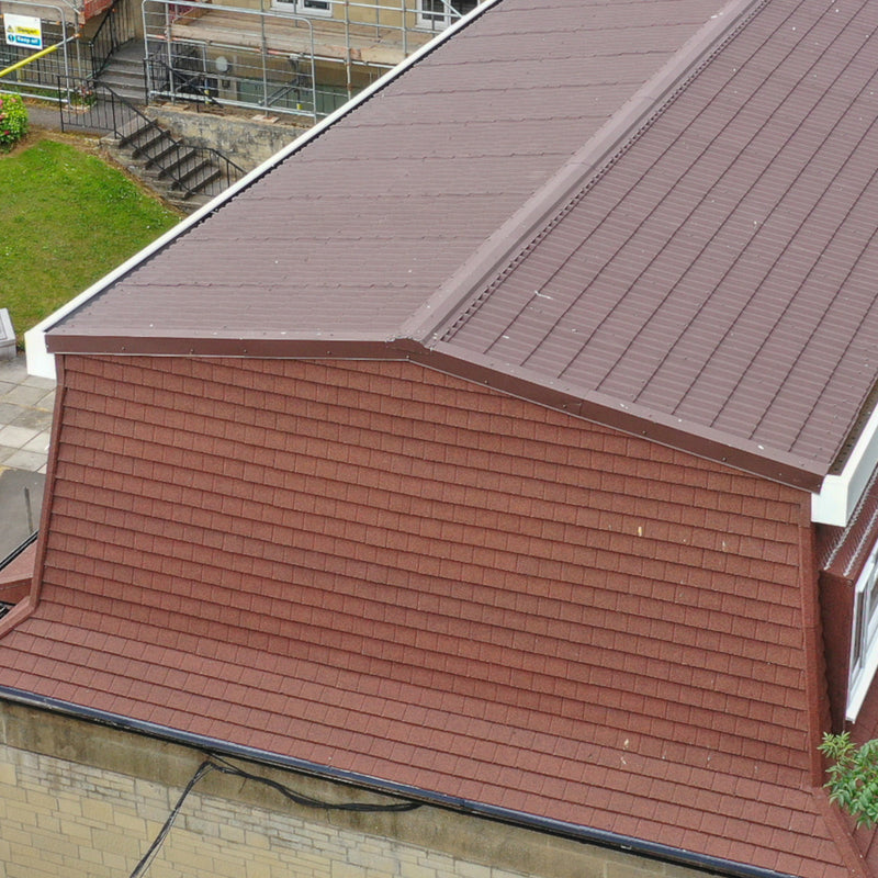 An image of roof fitted with Britmet Pantile 2000 tiles with Eave Flashing strip.