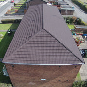 An image of a house with Britmet Pantile 2000 Roof Hip Flashing in the colour Mid Grey