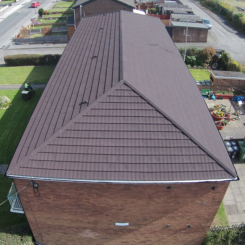 An image of a house with Britmet Pantile 2000 Roof Hip Flashing in the colour Mid Grey