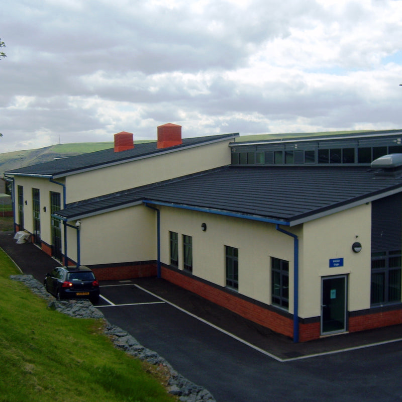 An image showing a school roof with Britmet Plaintile Roof Side Wall Right and left Hand strips