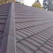 An image of a roof with Britmet Profile 49 tiles and finished with Mono Roof Ridge tiles.