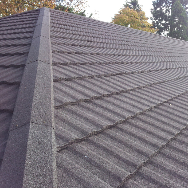 An image of a roof with Britmet Profile 49 tiles and finished with Mono Roof Ridge tiles.