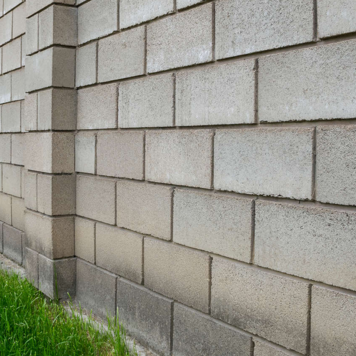 An image of Concrete Builders Solid Breeze Block / Cinder Block built into a wall.