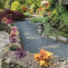 An image of Charcoal Slate Stone Chippings laid out on a garden path