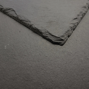 A close up image of Chinese Primera Roof Slates: 500 x 250 mm (20" x 10"), Close-up of a textured grey slate surface