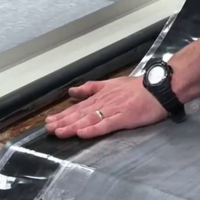 An image of a roll of ClassicBond Pressure Sensitive Strip Tape being applied to a join in rubber.