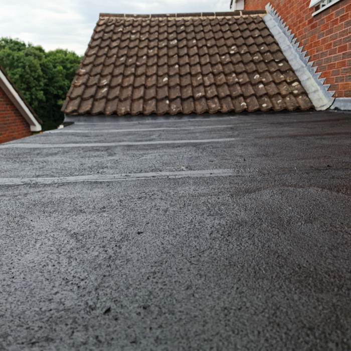 An image of a roof that has had Cromapol Acrylic Roof Coating in Black applied and shows the smart finish that is waterproof.