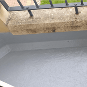 An image of a roof that has had Cromapol Acrylic Roof Coating in Grey applied and shows the smart finish that is waterproof.